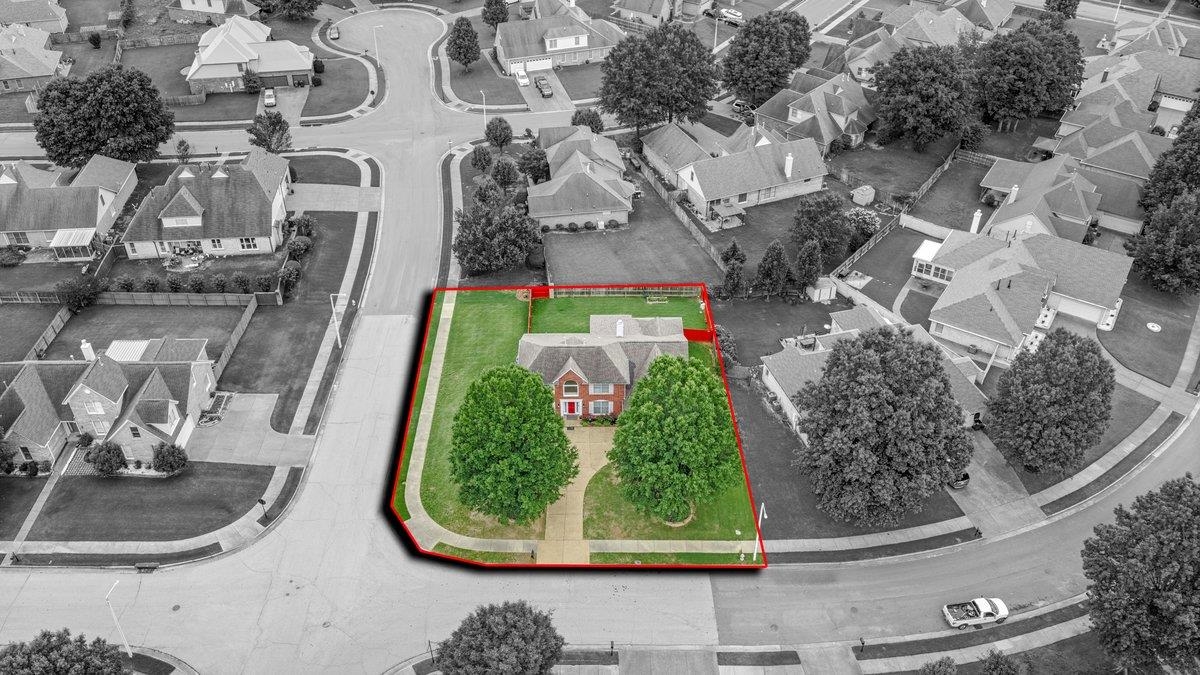 4840 Rainy Pass Road Collierville, TN 38017 - Photo 2 of 30 Aerial perspective showcasing a corner lot property with a red brick residence