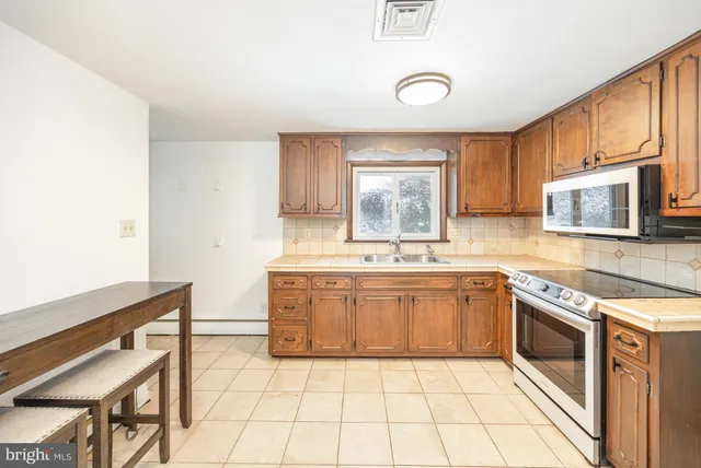 a kitchen with stainless steel appliances granite countertop a sink and cabinets