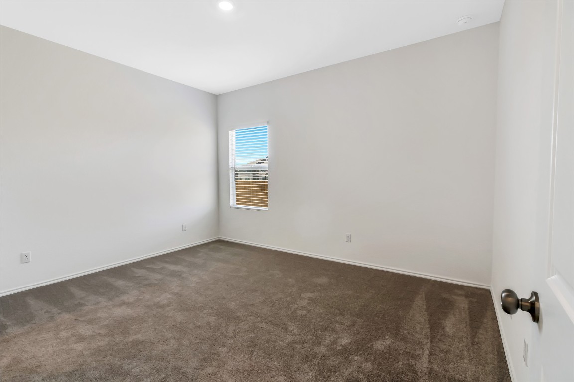 160 The Bad Way Jarrell, TX 76537 - Photo 13 of 33 Empty room with dark colored carpet