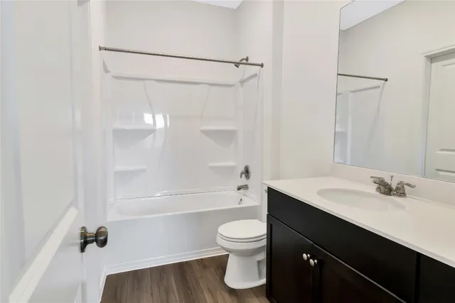 a bathroom with a sink toilet a mirror and shower