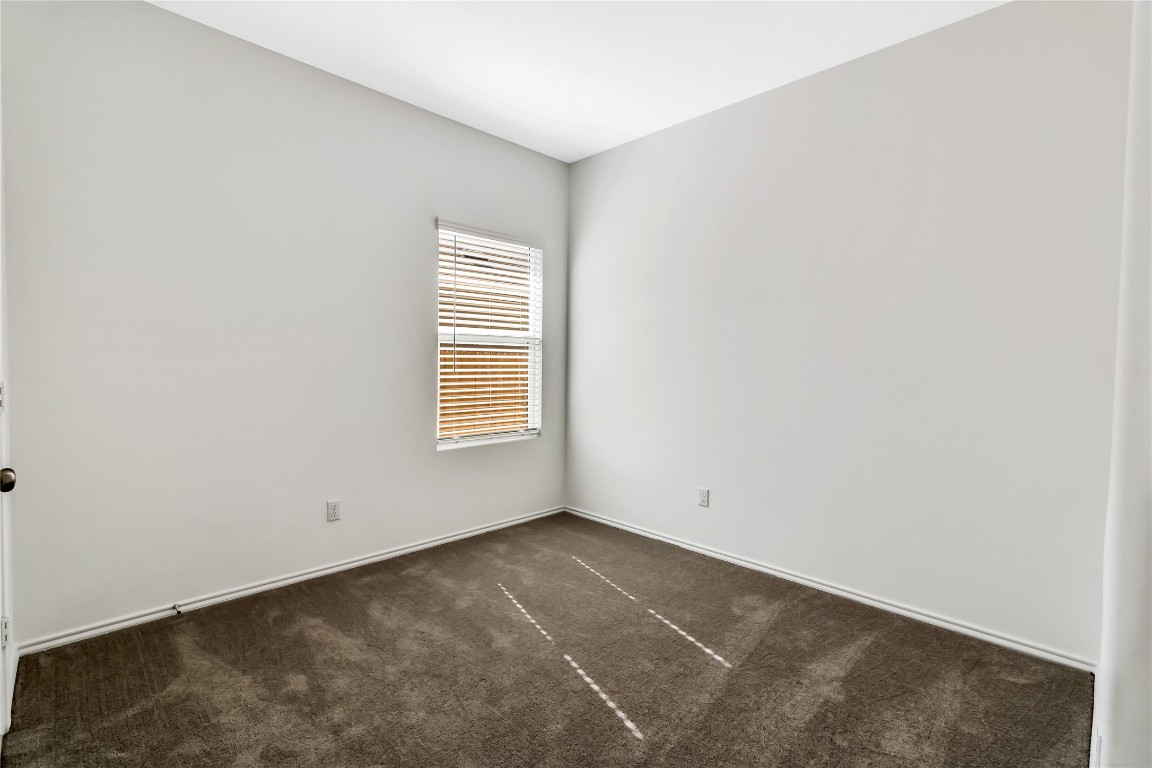 160 The Bad Way Jarrell, TX 76537 - Photo 28 of 33 Spare room featuring dark colored carpet and baseboards