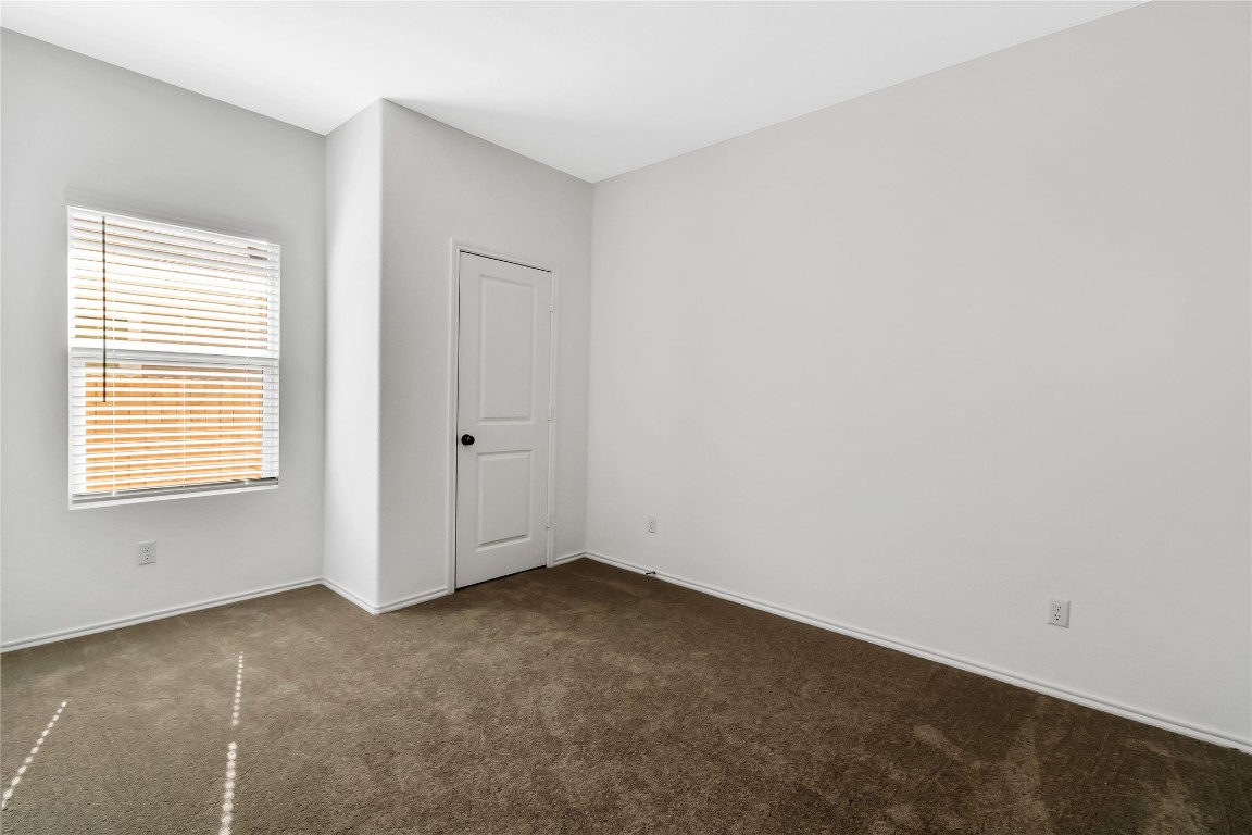 160 The Bad Way Jarrell, TX 76537 - Photo 29 of 33 Unfurnished room with dark carpet and baseboards