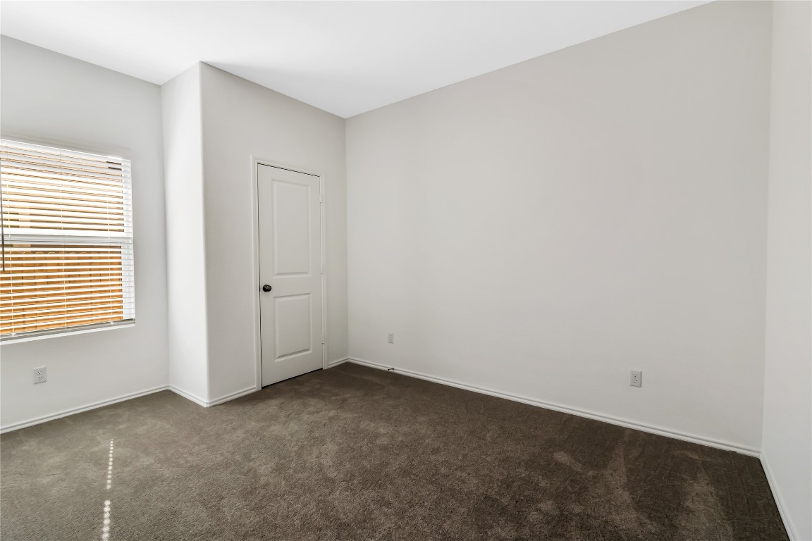 160 The Bad Way Jarrell, TX 76537 - Photo 30 of 33 Spare room featuring dark carpet and baseboards