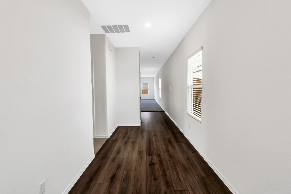 160 The Bad Way Jarrell, TX 76537 - Photo 4 of 33 Corridor featuring dark wood-style flooring and recessed lighting