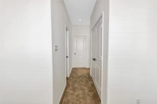 a view of a hallway with a white door