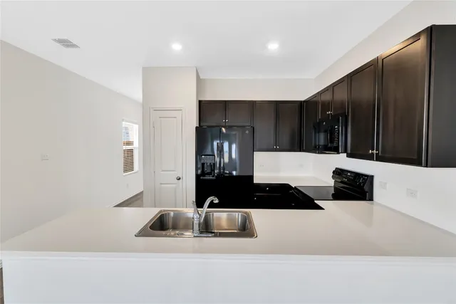 a kitchen with a sink and cabinets