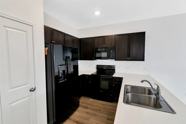 a kitchen with a sink and a refrigerator
