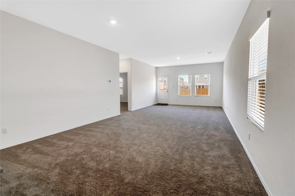 160 The Bad Way Jarrell, TX 76537 - Photo 10 of 33 Spare room with dark colored carpet and recessed lighting
