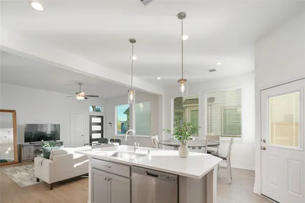a kitchen with sink stove and living room