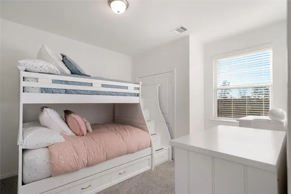 a bedroom with a bed and window