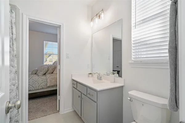 a en suite bathroom with a sink and a mirror
