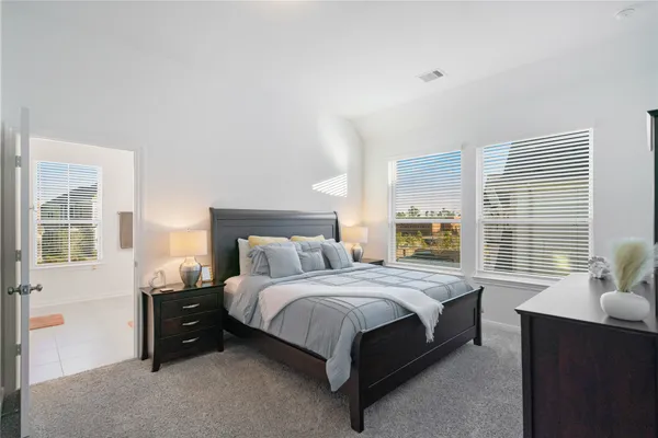 a bedroom with a bed and a couch