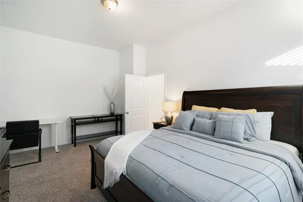 a bedroom with a bed and a chair