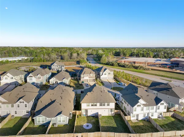 an aerial view of a house with garden space and ocean view