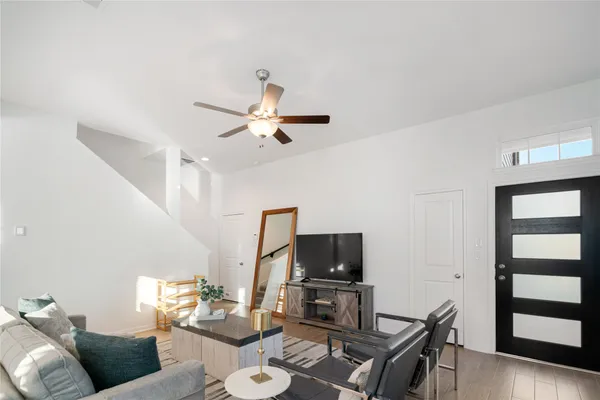 a living room with furniture a dining table and a flat screen tv