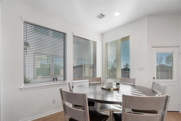 a view of a dining room with furniture and windows