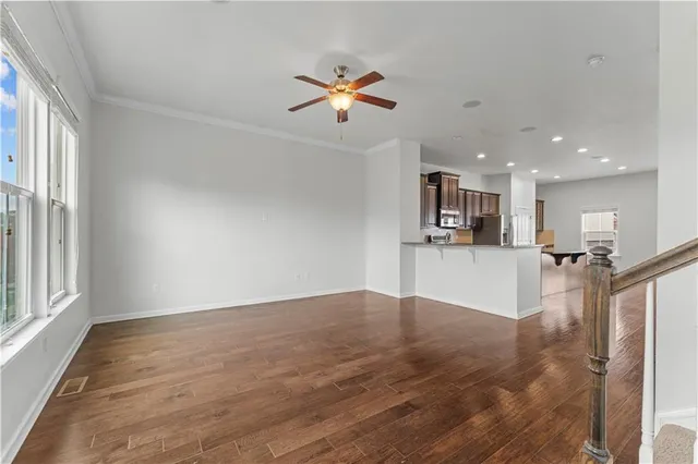 a view of a kitchen with wooden floor and a kitchen