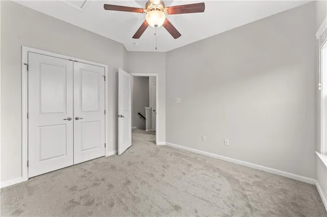 an empty room with chandelier fan