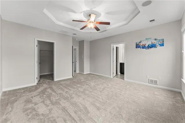 a view of an empty room with a ceiling fan