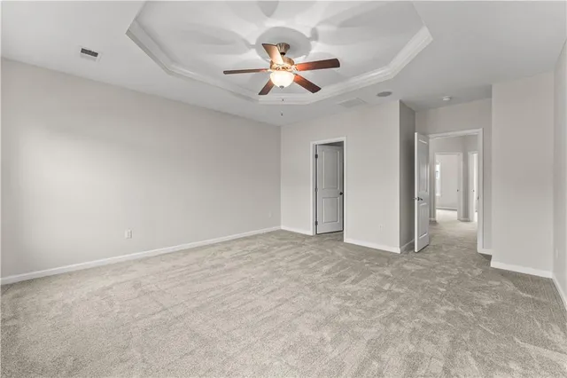 a view of an empty room with a ceiling fan