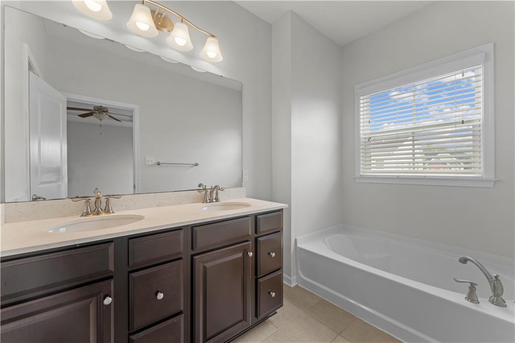818 Oneida Circle Mars, PA 16046 - Photo 33 of 45 a bathroom with a tub double sink window and mirror