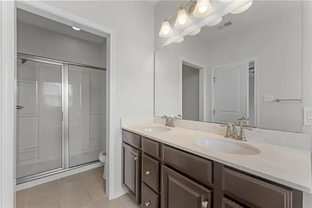 a bathroom with a sink a light fixture and a mirror
