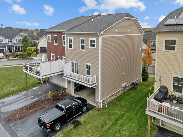 a view of a house with a deck and a yard