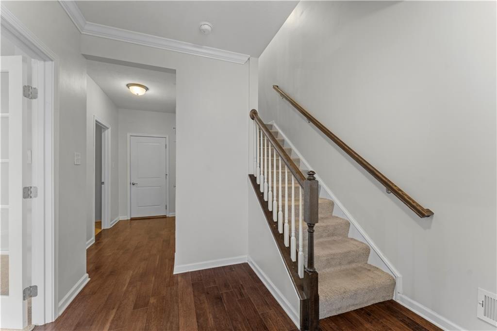 818 Oneida Circle Mars, PA 16046 - Photo 5 of 45 a view of a hallway with wooden floor and staircase