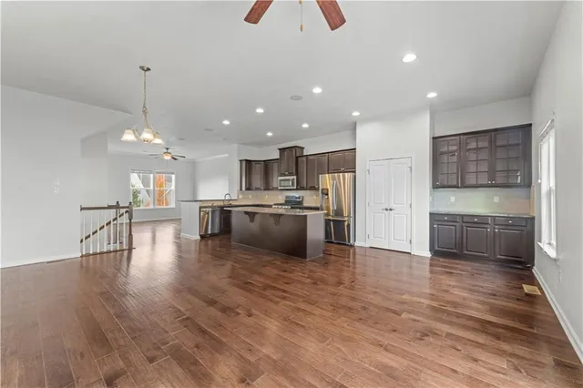 a kitchen with stainless steel appliances a refrigerator sink and cabinets