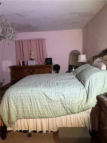 a bedroom with two beds and a couch