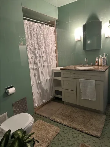 a bathroom with a toilet sink and mirror