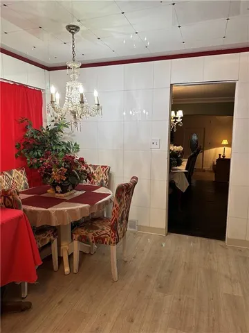 a view of a dining room with furniture and chandelier
