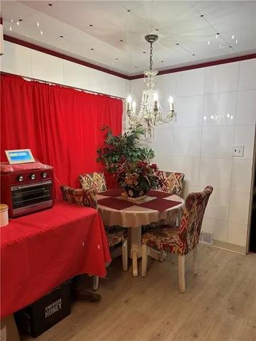 a view of a dining room with furniture and chandelier
