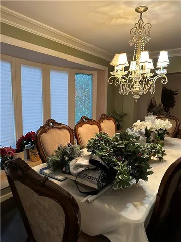 a table with a flower pot and a chandelier