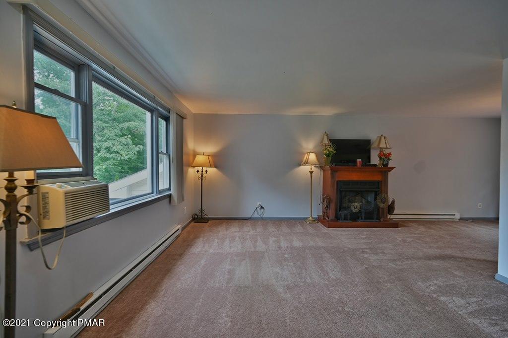 273 Devils Hole Road Cresco, PA 18326 - Photo 15 of 59 a view of an empty room with a fireplace and a window