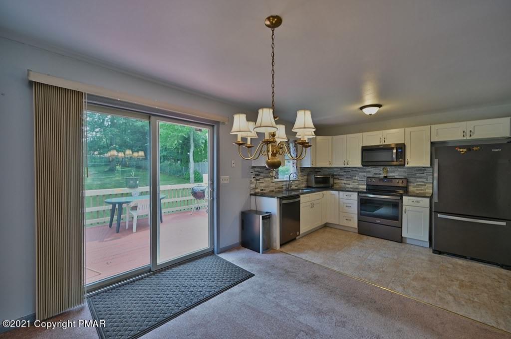 273 Devils Hole Road Cresco, PA 18326 - Photo 17 of 59 a kitchen with refrigerator a stove and furniture