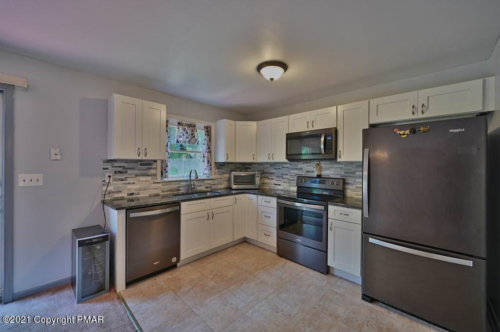 273 Devils Hole Road Cresco, PA 18326 - Photo 18 of 59 a kitchen with stainless steel appliances granite countertop a refrigerator stove and sink