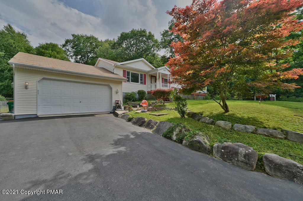 273 Devils Hole Road Cresco, PA 18326 - Photo 2 of 59 a front view of a house with a yard and garage