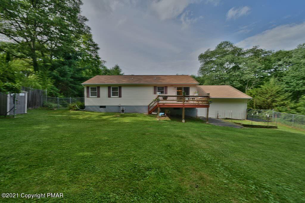 273 Devils Hole Road Cresco, PA 18326 - Photo 52 of 59 a front view of a house with a garden and yard