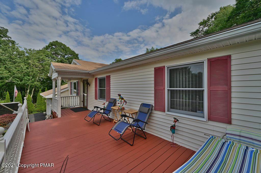 273 Devils Hole Road Cresco, PA 18326 - Photo 6 of 59 a view of a patio with table and chairs with wooden floor and fence