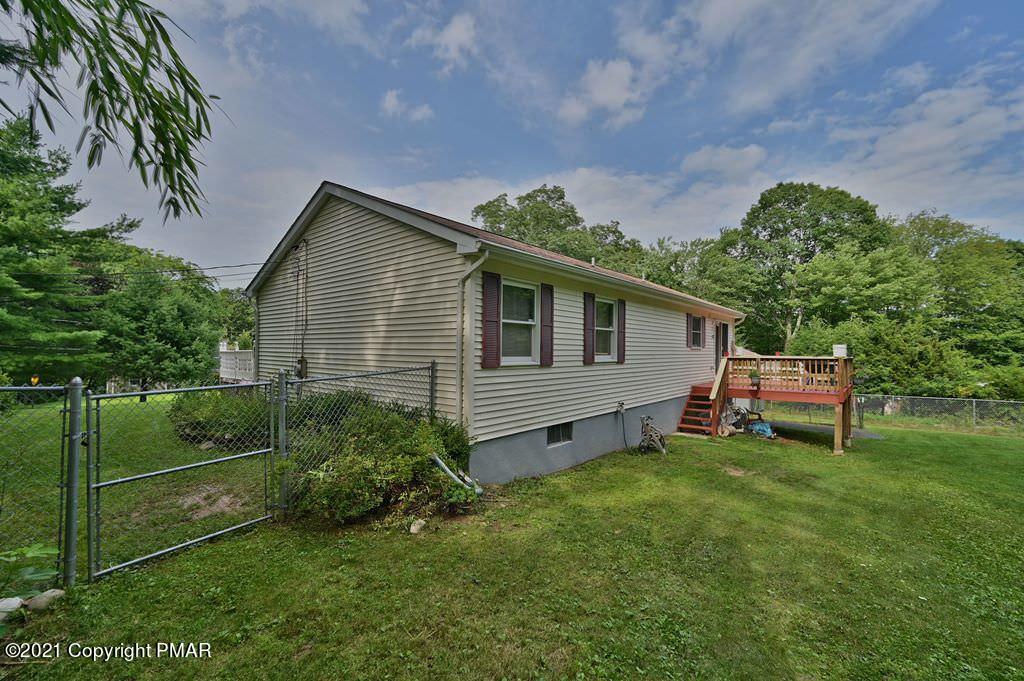 273 Devils Hole Road Cresco, PA 18326 - Photo 9 of 59 a backyard of a house with table and chairs
