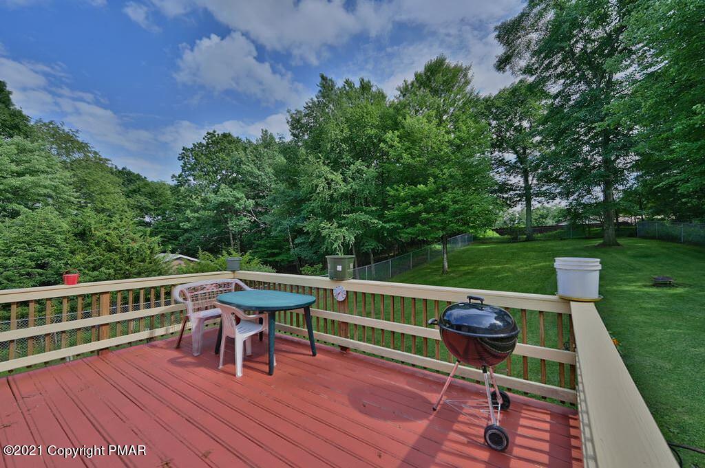 273 Devils Hole Road Cresco, PA 18326 - Photo 10 of 59 a view of a chairs and table on the wooden deck