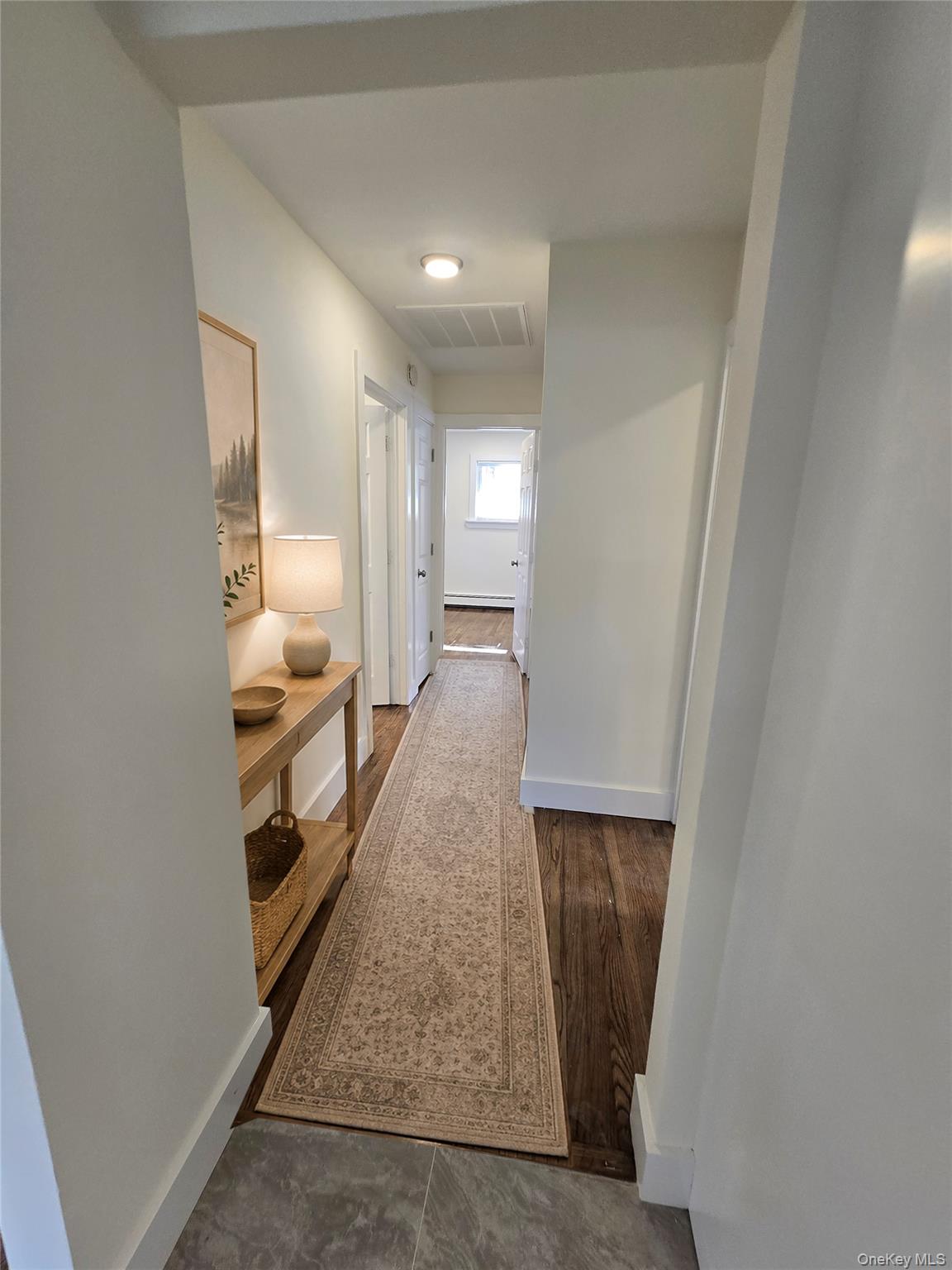 90 Blue Point Road Selden, NY 11784 - Photo 9 of 19 Hallway featuring wood-finish flooring, white baseboards, and overhead recessed lighting