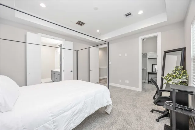 a bedroom with a bed and a table