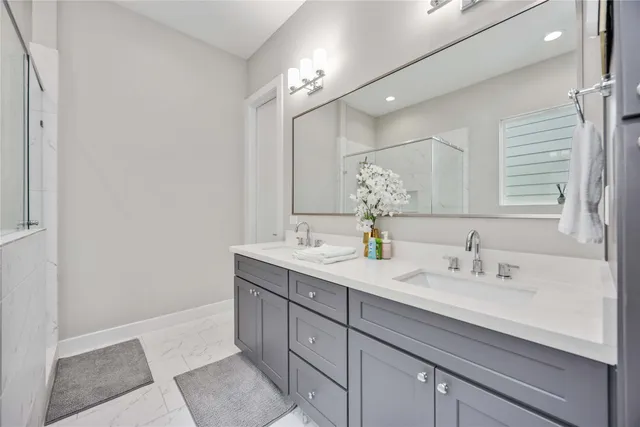 a bathroom with a sink a light fixture and a mirror