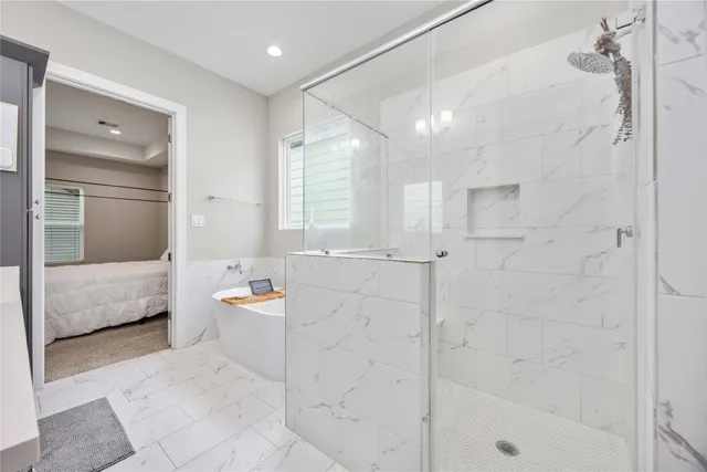 a bathroom with a tub sink and mirror