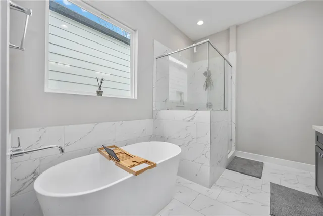 a bathroom with a tub and a shower