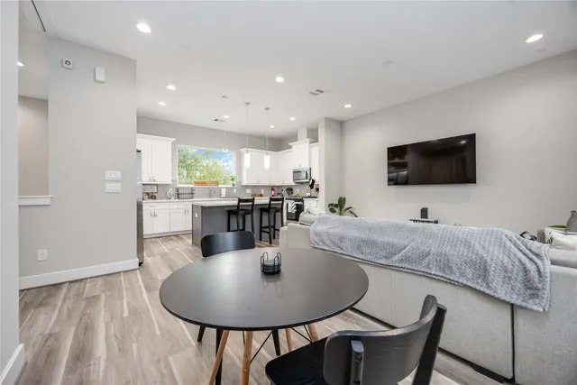 a dining room with furniture and wooden floor