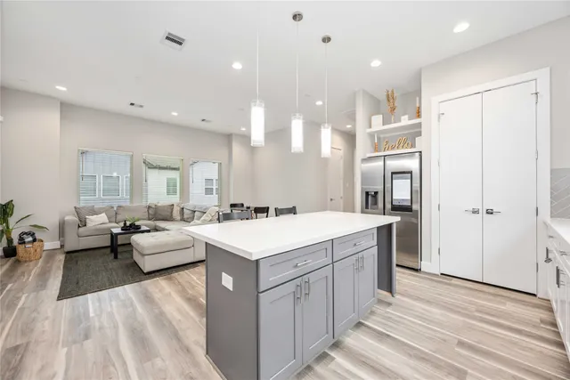 a large white kitchen with a large window