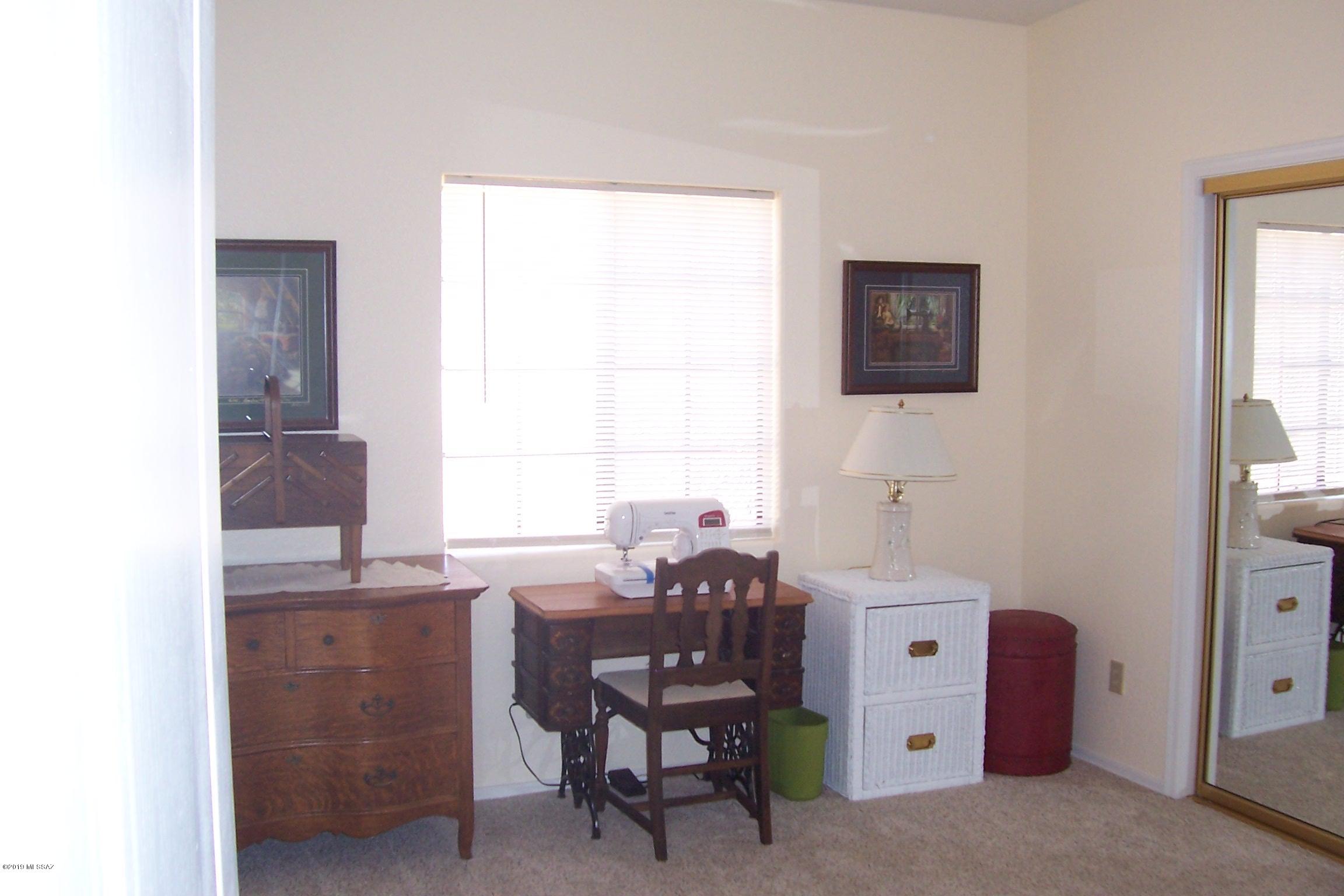 1256 Avenida Gloriosa Rio Rico, AZ 85648 - Photo 16 of 25 a room with a desk and chair